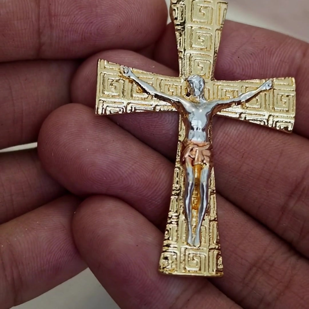 Greek key crucifix pendant in hand, textured gold with two-tone corpus