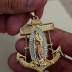 Virgen de Guadalupe anchor pendant, angled view in hand