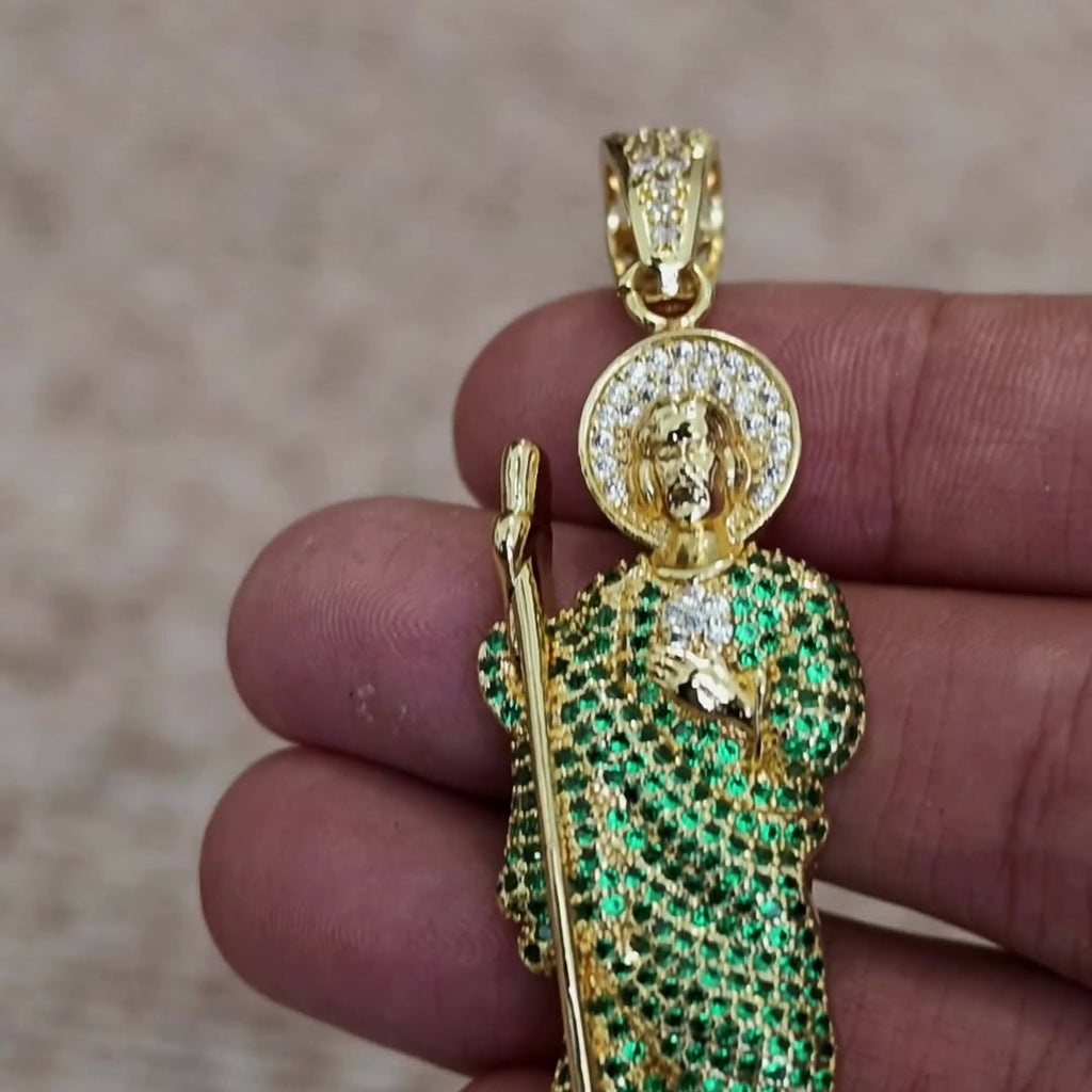San Judas Tadeo iced figure pendant with green CZ robe held in hand