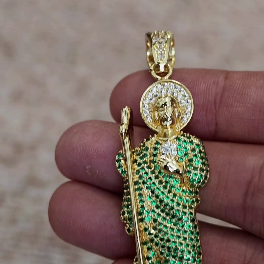 San Judas Tadeo iced figure pendant with green CZ robe held in hand