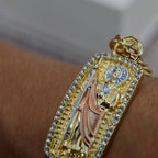 San Judas Tadeo tri-tone ID bracelet worn on the wrist, close-up