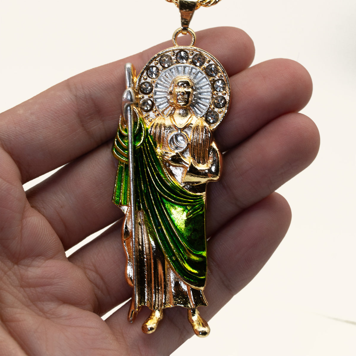 San Judas Tadeo green enamel robe pendant held in hand to show its size