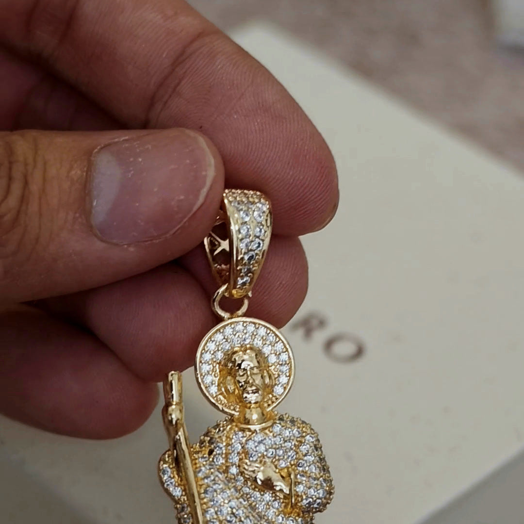 San Judas Tadeo white CZ figure pendant, pavé halo and bail, close-up in hand