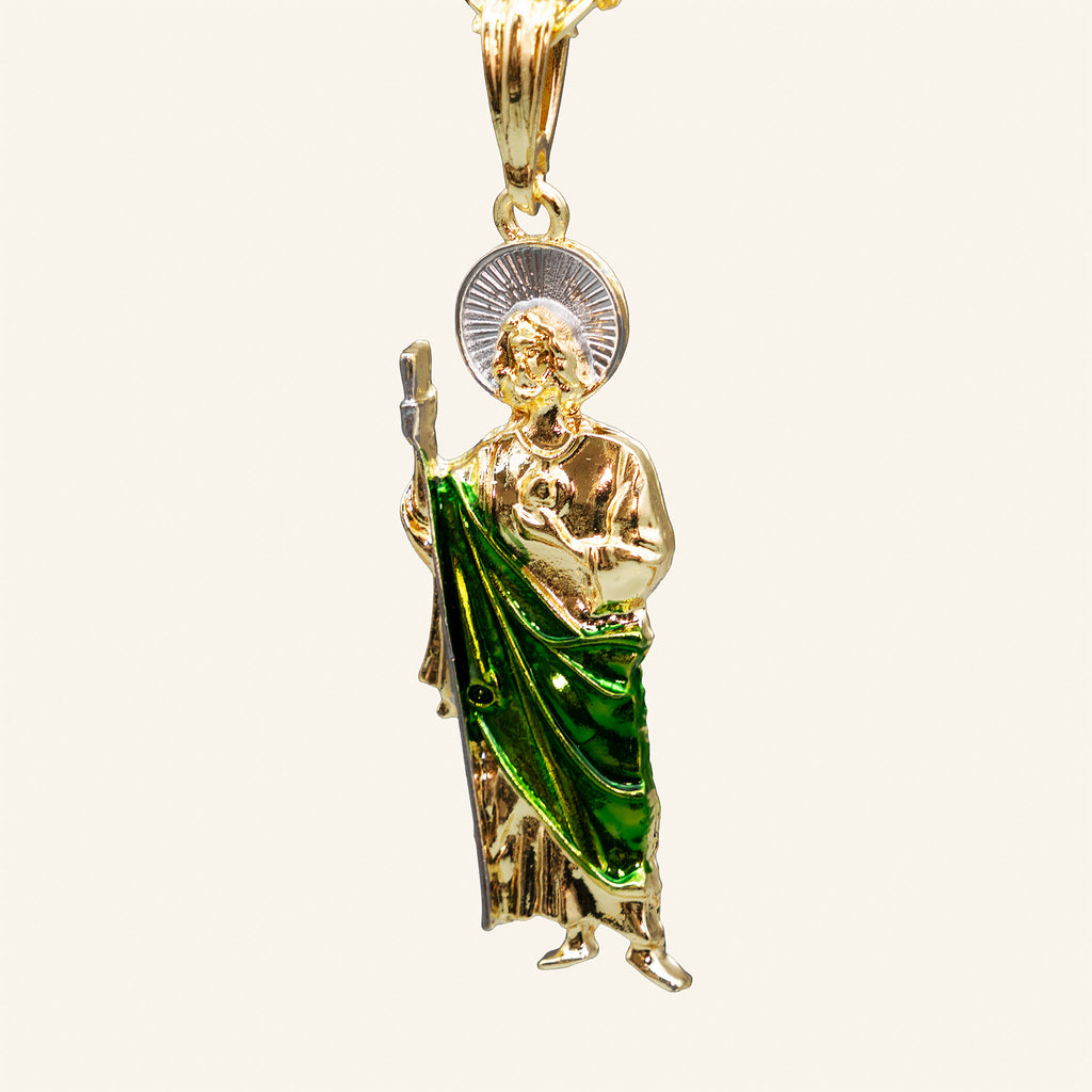 Close-up of San Judas Tadeo pendant with green enamel robe, staff and medallion