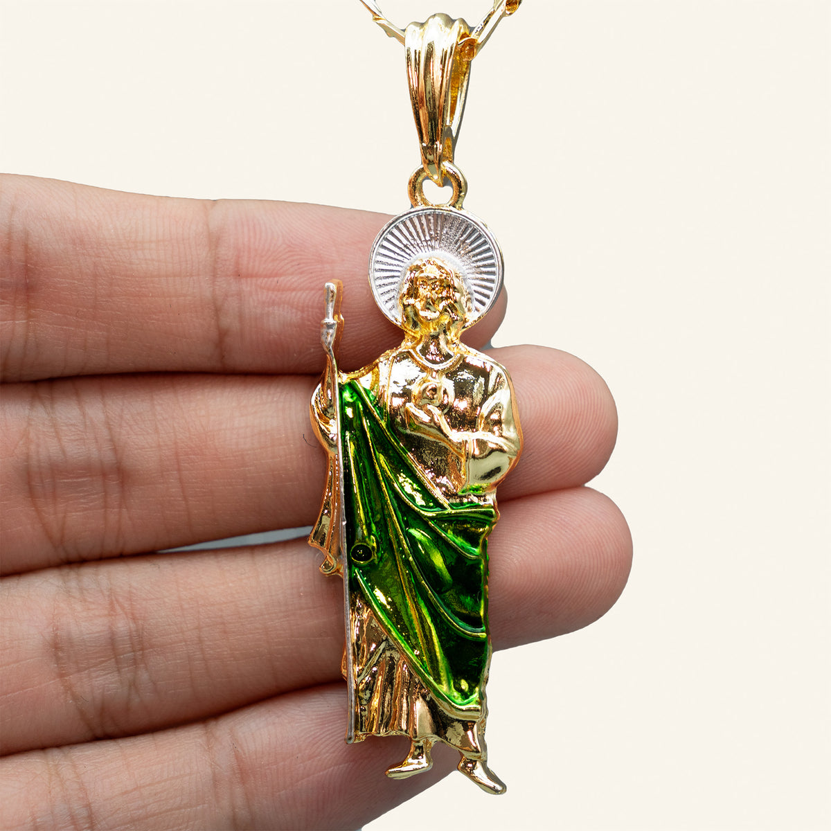San Judas Tadeo figure pendant in hand for size reference